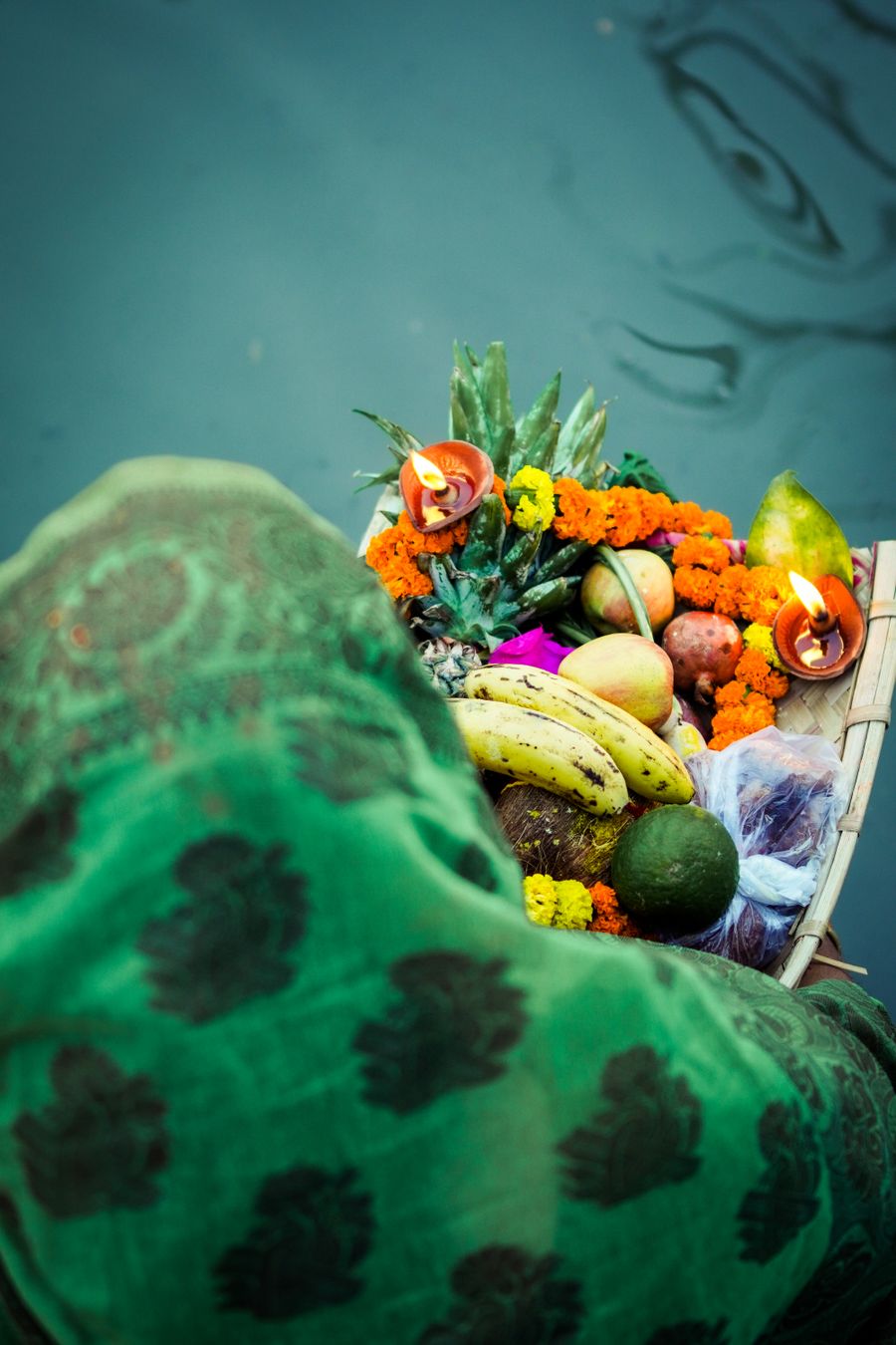 Chhath offering basket with diyas and marigolds